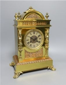 A late Victorian copper and brass mantel clock - 39cm tall